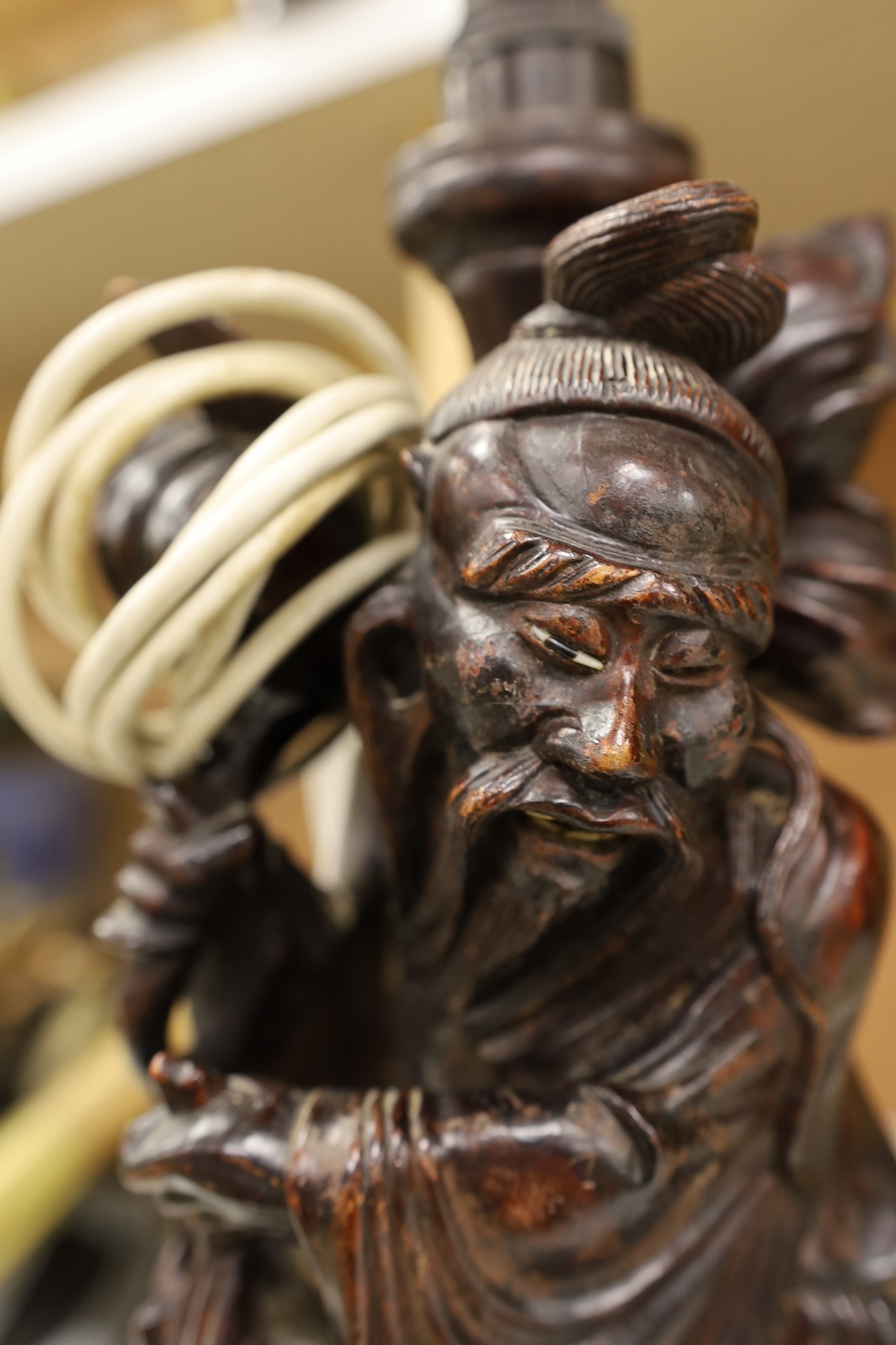 A Chinese carved wooden figural table lamp base, 36cm high not including light fitting. Condition - rubbed in places